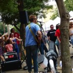 Band playing music with a crowd listening.