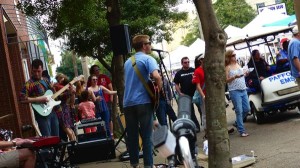 Band playing music with a crowd listening.