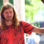 Man with long hair in red shirt.