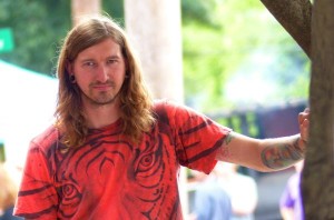 Man with long hair in red shirt.