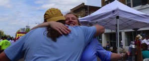 Man and woman hugging under a tent.