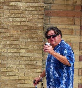 Man in blue shirt holding a can.