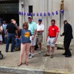 Group of people gathered outside a building.