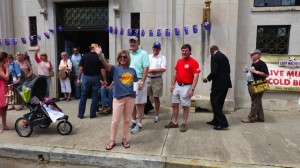 Group of people gathered outside a building.