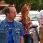 Man in denim jacket with a woman in floral dress