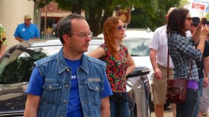 Man in denim jacket with a woman in floral dress