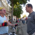 Two men talking on a sunny day.