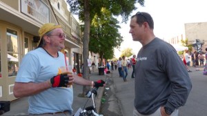 Two men talking on a sunny day.