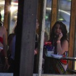 Women gathered around a table, smoking and chatting.