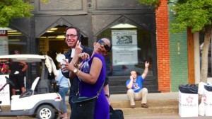 Woman with sunglasses smiles near a man.