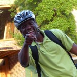 Smiling man in a helmet pointing at the camera.