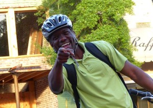 Smiling man in a helmet pointing at the camera.