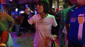 Woman with short brown hair wearing a white shirt.