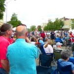 A group of people gather outdoors at a festival.