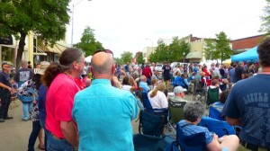 A group of people gather outdoors at a festival.