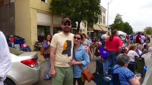 Couple smiles with friends at outdoor event.