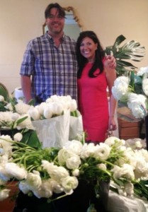 Couple with white flowers at a party.