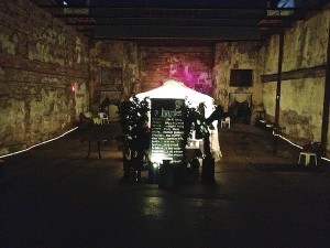 A playbill for Hamlet in a brick warehouse.