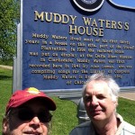 Muddy Waters House historical marker with two men.