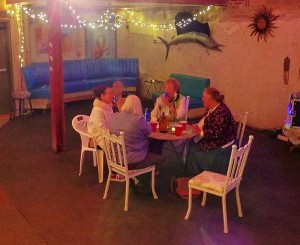 Four people sit around a table in a room.