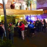 Group of people at a bar inside a building.