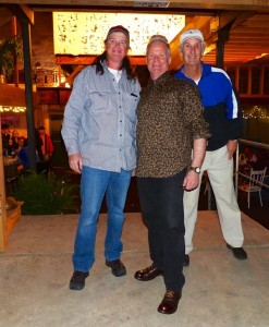 Three men standing together smiling for a photo.