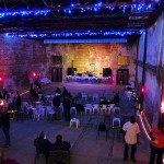 People gathered in a brick building with blue lights.