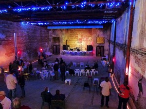 People gathered in a brick building with blue lights.