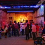 A concert in a brick building with people watching.