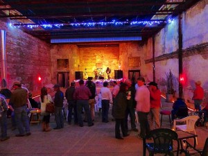 A concert in a brick building with people watching.