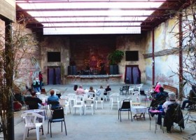 People sitting at tables in a large, open space.