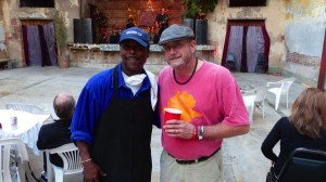 Two men standing together smiling at a party.