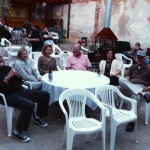 Group of friends gathered around a table outside.