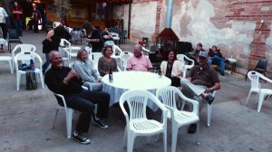 Group of friends gathered around a table outside.