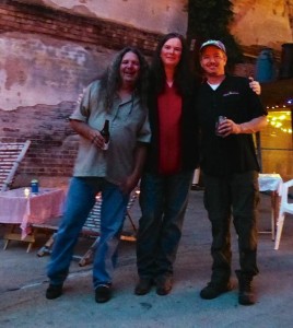 Three men smiling and posing for a photo.