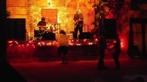 Live band playing on a stage with lights.