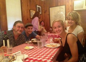 A group of people gathered around a table enjoying a meal.