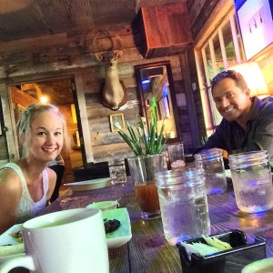 Woman and man sitting at a table with drinks.
