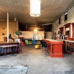 Empty bar with red counter and stools.