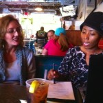 Three women sitting in a restaurant.