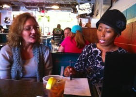 Three women sitting in a restaurant.