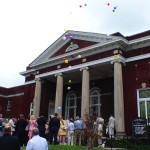 People release balloons at a church wedding.