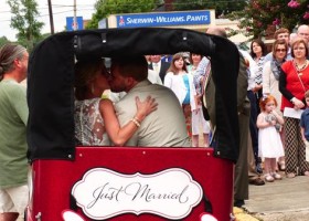 Newlyweds in a horse-drawn carriage, just married.