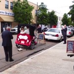 Wedding couple in a horse-drawn carriage.