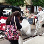 Bride and groom getting into a rickshaw.