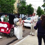 Bride and groom in a red rickshaw.