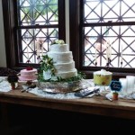 Wedding dessert table with cakes and pudding.