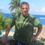 Man wearing green Delta Bohemian t-shirt.