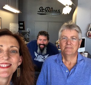 Three people, one man peeking behind the camera.