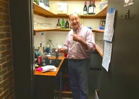 Man making a drink in a home bar.